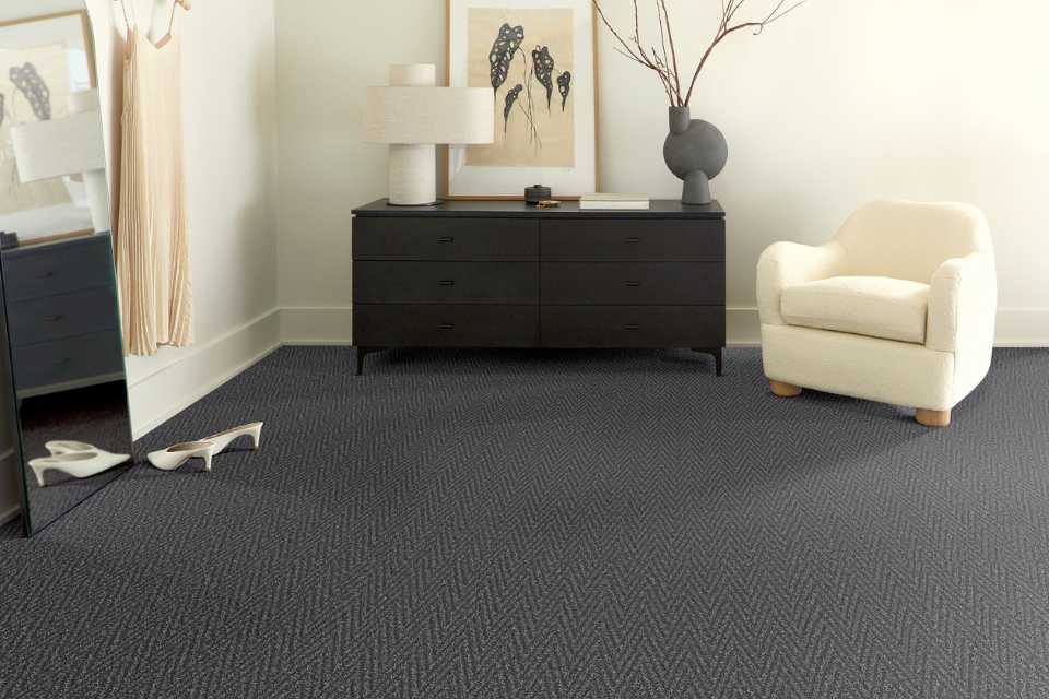 dark patterned carpet in bedroom with black detailing